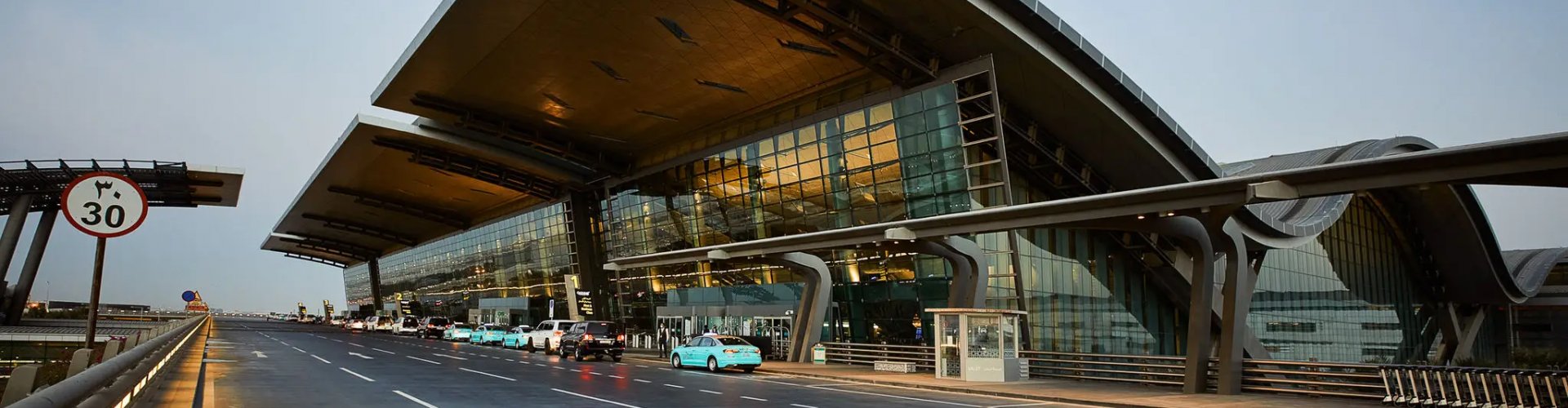 Sunset view of Doha Intl Airport terminal