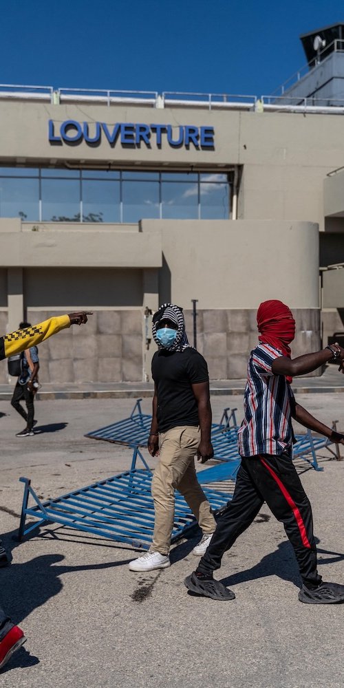 Parent and child resting comfortably during off-peak hours at Cap Haitien Airport