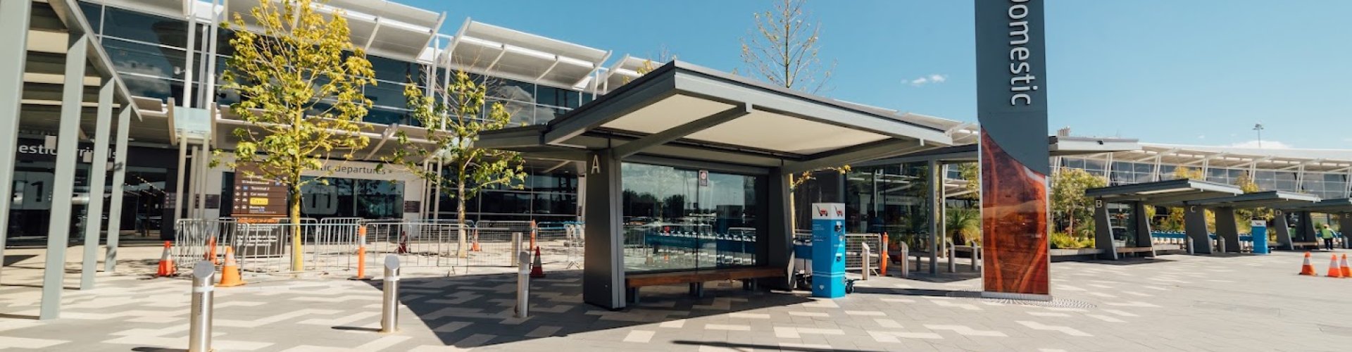 Sunset view of Perth Intl Airport terminal with family walking